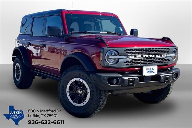 2026 Ford Bronco Badlands in Ruby Red Metallic Tinted Clearcoat — front three-quarter view
