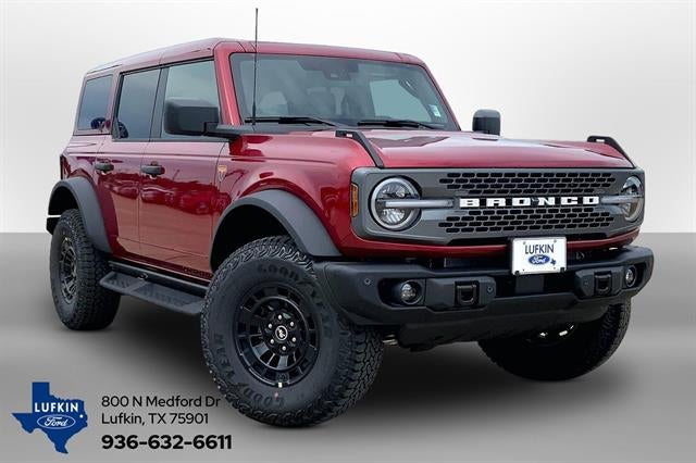 2026 Ford Bronco Badlands in Ruby Red Metallic Tinted Clearcoat — front three-quarter view